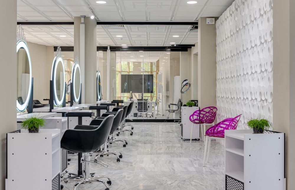 Illustrative row of lit salon mirrors, not the actual studio