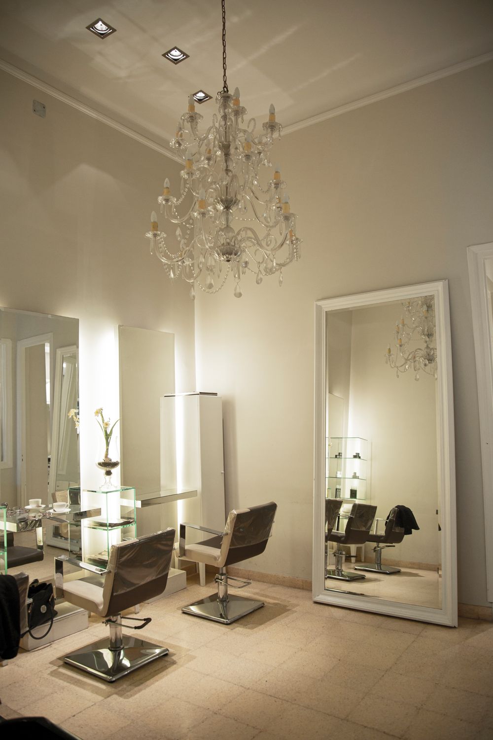 Illustrative salon interior with chandelier and styling chairs, not the actual studio